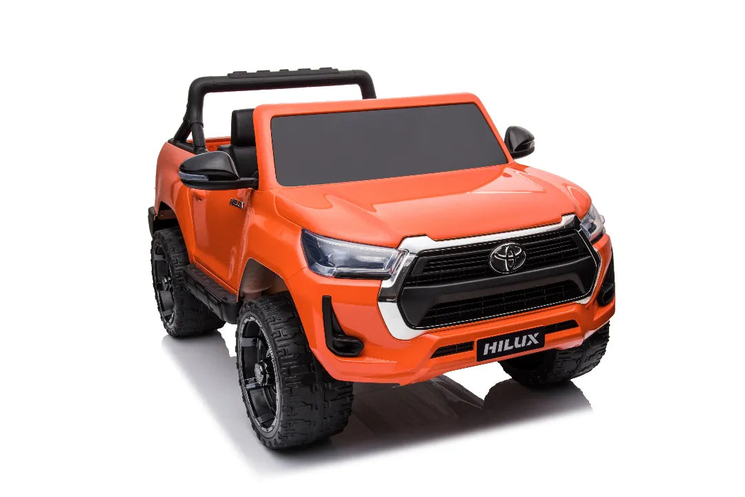 Bright orange 24V licensed Toyota Hilux SR5 4x2 2-seater kids ride-on ute with black wheels and side mirrors