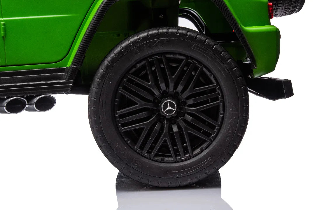 Close-up of black alloy wheel with Mercedes emblem on green 24V 14Ah licensed AMG G63 kids ride-on car