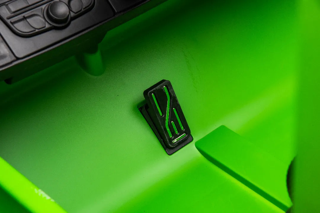 Close-up of black pedal inside green 24V 14Ah licensed Mercedes-AMG G63 kids ride-on car interior.