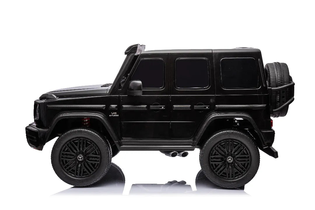 Side view of black 24V 14Ah licensed Mercedes-AMG G63 800W 4x4 kids ride-on car with spare tire mount