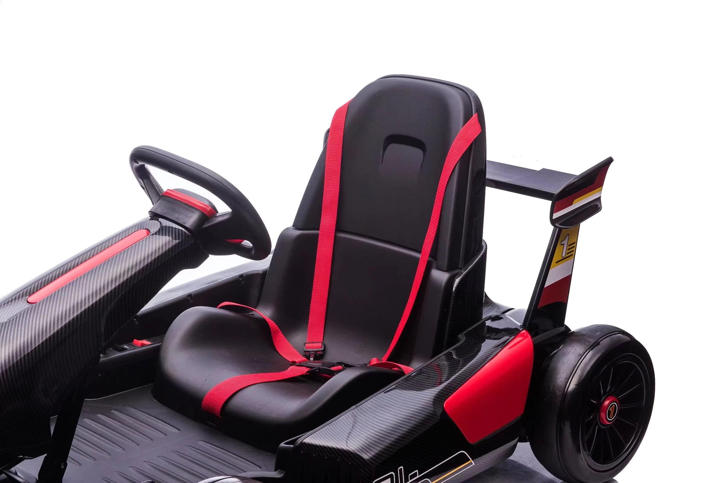 Close-up of black seat with red safety harness and steering wheel on pink 24V electric go-kart for kids with drift function