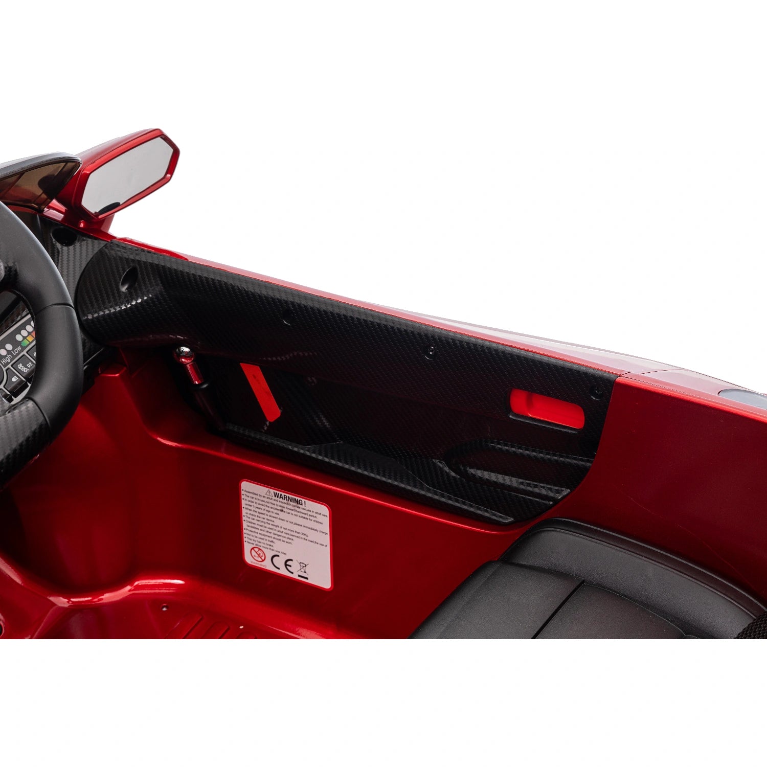 Interior close-up of spray painted red Lamborghini Veneno ride-on car showing black leather seat and detailed dashboard panel